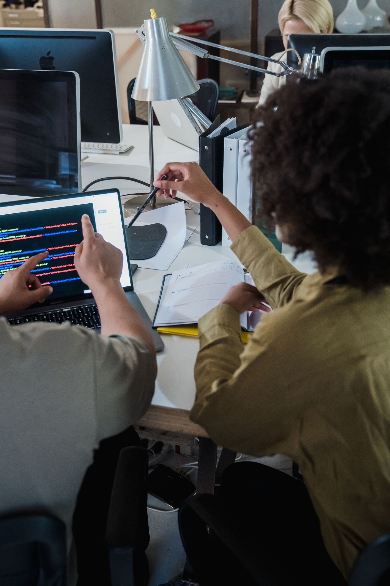Developers reviewing code together at a desk
